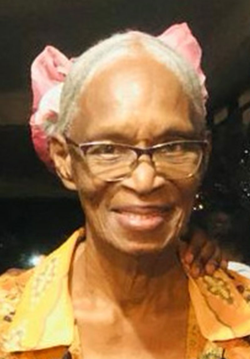 Sister Phyllis Newby, faithful missionary to Haiti since 1972, smiling warmly in a colorful headscarf and glasses