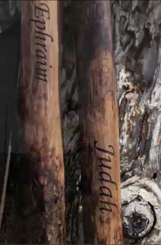 Close-up of engraved wooden sticks labeled Ephraim and Judah representing biblical unity from Ezekiel 37